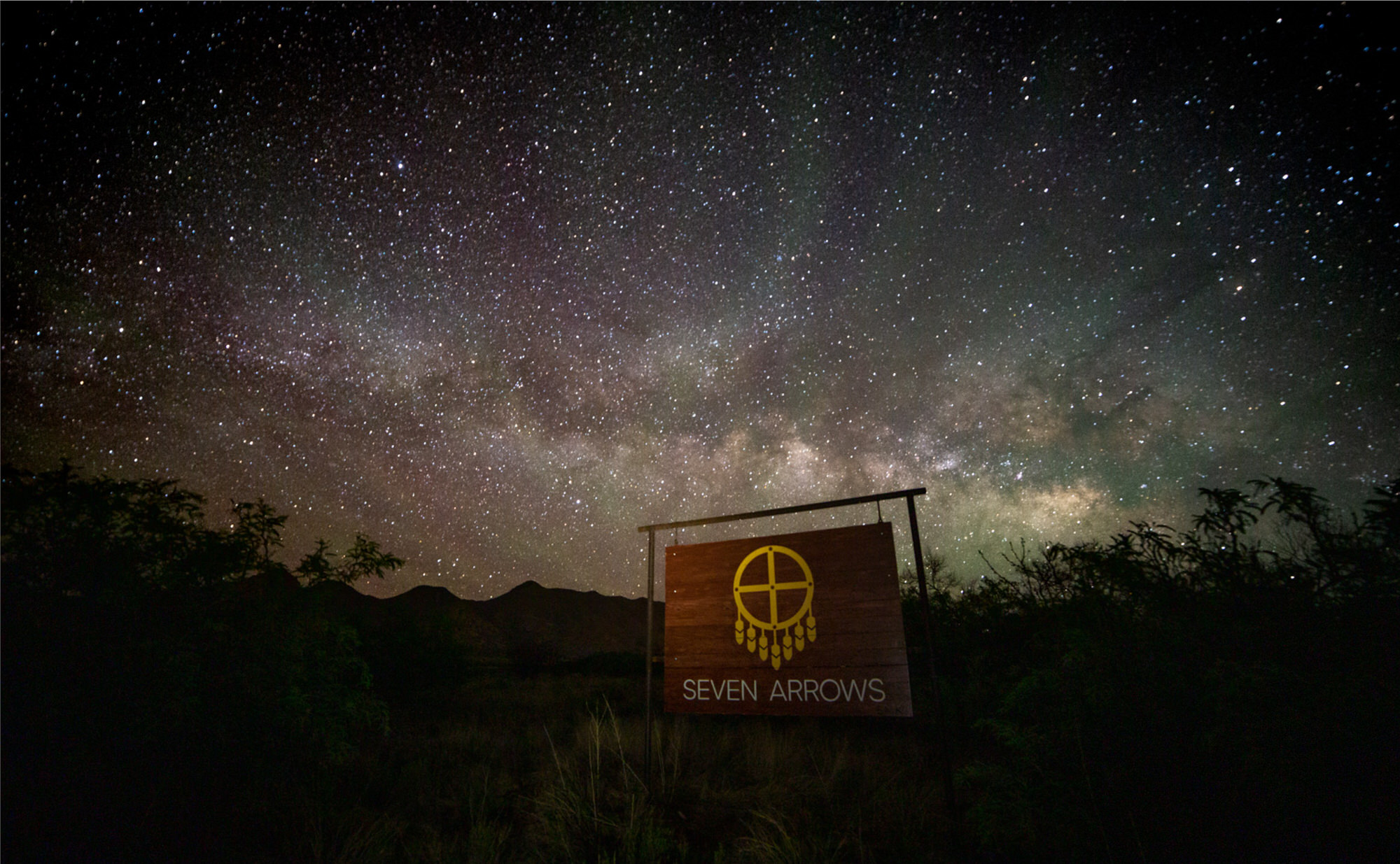 Seven Arrows sign beneath the Milky Way
